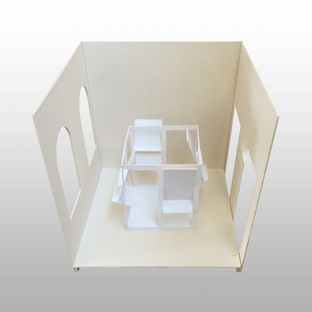 Front view of the final physical model showing the central exhibition structure within the library space