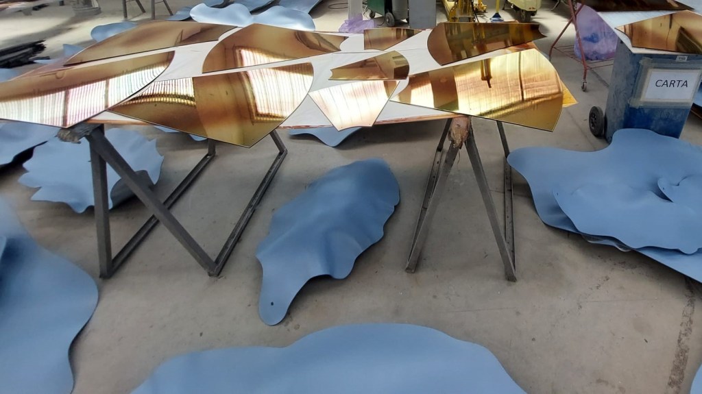 Gold and blue sculptural window components for the Louis Vuitton Blooming Flowers campaign during production and quality control