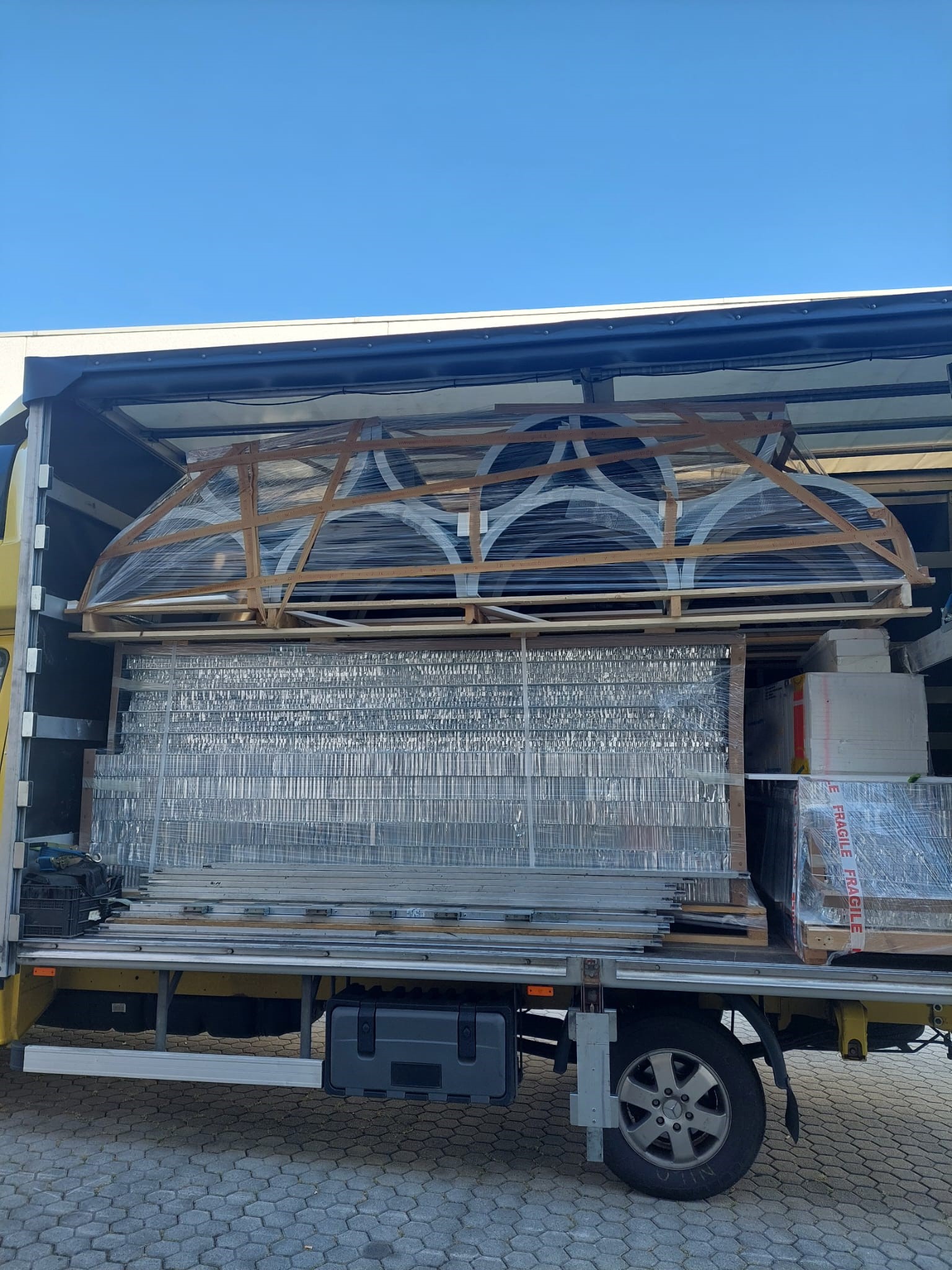 Truck loaded with protected Louis Vuitton window components prepared for shipment and installation