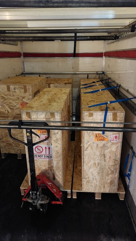 Transport vehicle loaded with Kering Eyewear showroom crates during the Milan dismantling return flow