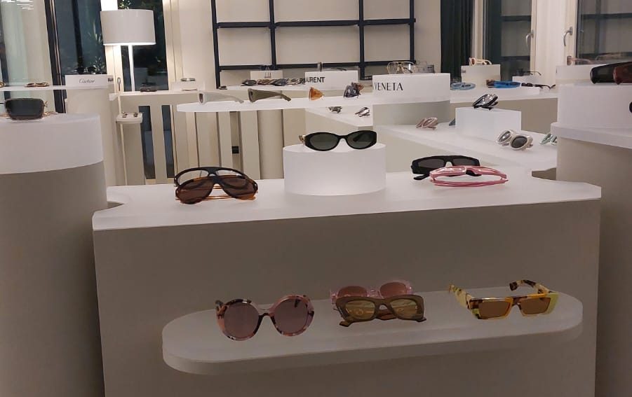 Kering Eyewear showroom display in Milan featuring multi-brand eyewear presentation units