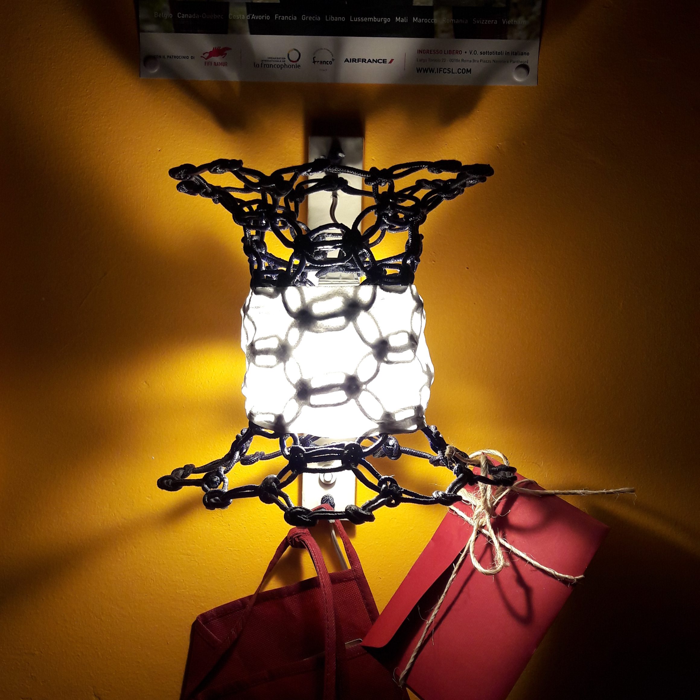 Illuminated Knotlight wall lamp prototype with woven rope structure and integrated lighting system