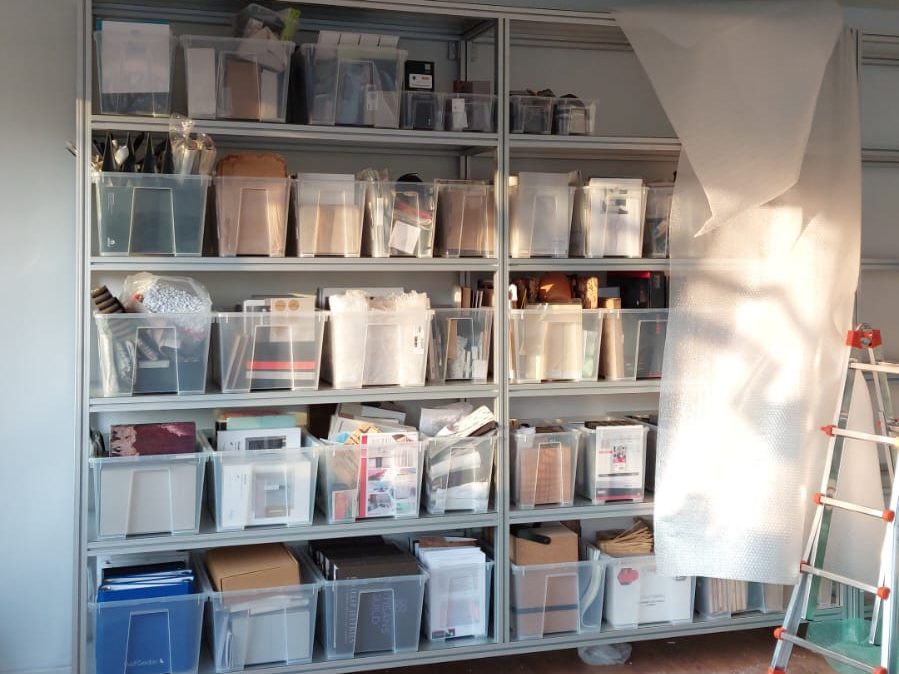 Material samples being transferred into the new shelving system during the Oltrefrontiera Material Library setup