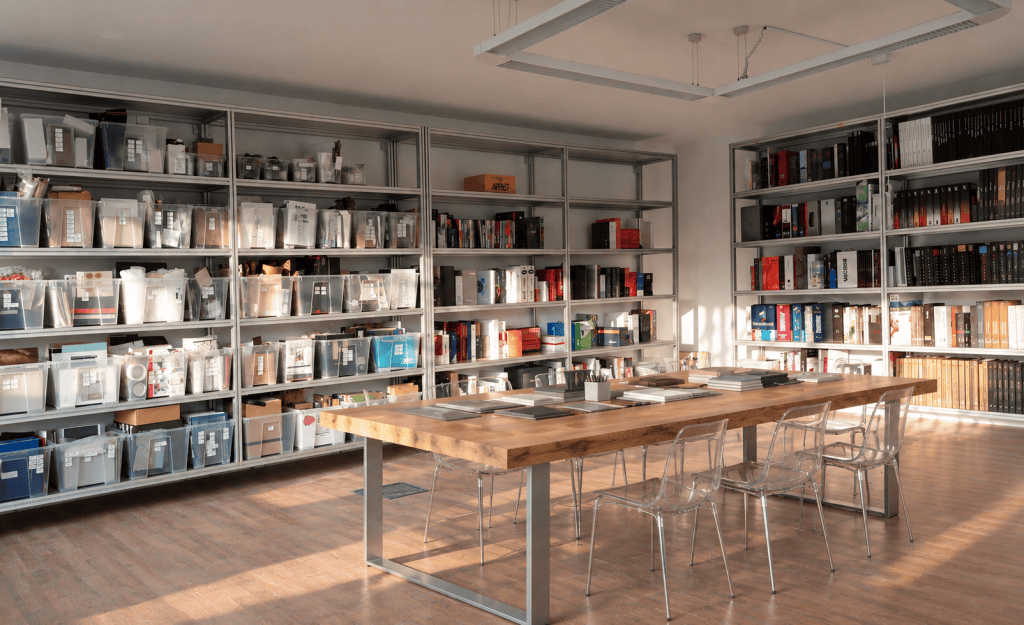 Digital rendering of the completed Oltrefrontiera Material Library with shelving, material archive and central worktable