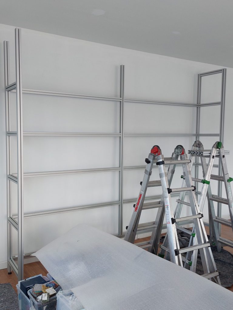 Installation of the custom aluminium shelving system designed for the Oltrefrontiera Material Library